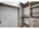 Bright walk-in closet with custom shelving and drawers at 805 Padua Ct, Nokomis, FL 34275