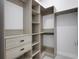 Spacious walk-in closet with custom shelving and drawers for optimal organization at 805 Padua Ct, Nokomis, FL 34275