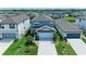Aerial view of a well-maintained two-story home with lush landscaping and a two-car garage at 8940 Royal River Cir, Parrish, FL 34219