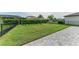 Spacious backyard with well-manicured lawn, secure black fence, and neatly trimmed hedges for privacy at 8940 Royal River Cir, Parrish, FL 34219