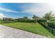Spacious backyard with well-manicured lawn, secure black fence, and neatly trimmed hedges for privacy at 8940 Royal River Cir, Parrish, FL 34219