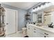 Bathroom with double vanity, modern fixtures, decorative shelves, and a glass shower at 8940 Royal River Cir, Parrish, FL 34219