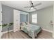 Modern bedroom with a queen size bed, a ceiling fan, woodgrain vinyl flooring and a built-in Murphy bed frame at 8940 Royal River Cir, Parrish, FL 34219