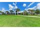 Community center exterior featuring lush landscaping and a modern architectural design at 8940 Royal River Cir, Parrish, FL 34219