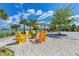 Outdoor firepit area with Adirondack chairs, lake views, and beautiful landscaping at 8940 Royal River Cir, Parrish, FL 34219