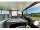 Relaxing covered back porch showcases a luxurious hot tub, perfect for unwinding and enjoying the outdoors at 8940 Royal River Cir, Parrish, FL 34219