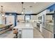 Kitchen with white cabinets, stainless steel appliances, kitchen island, and dining table at 8940 Royal River Cir, Parrish, FL 34219