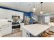 Kitchen with white cabinets, kitchen island, and stainless steel appliances at 8940 Royal River Cir, Parrish, FL 34219