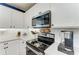 Kitchen with white cabinets, stainless steel appliances, and white subway tile backsplash at 8940 Royal River Cir, Parrish, FL 34219