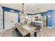 Eat in kitchen with white cabinets, kitchen island with barstool seating and dining table at 8940 Royal River Cir, Parrish, FL 34219