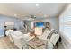 Comfortable living room with gray couches, stairway, and light gray colored walls at 8940 Royal River Cir, Parrish, FL 34219