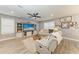 Spacious living room featuring comfortable seating, a large entertainment center, and natural light at 8940 Royal River Cir, Parrish, FL 34219