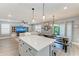 Open concept floor plan with kitchen island, dining area, and living room at 8940 Royal River Cir, Parrish, FL 34219