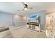 Loft featuring neutral carpet, a ceiling fan, a sofa, an office area, and a TV above a console table at 8940 Royal River Cir, Parrish, FL 34219
