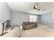 Loft featuring neutral carpet, a ceiling fan, a sofa, and an office area with natural light at 8940 Royal River Cir, Parrish, FL 34219