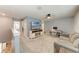Loft with neutral carpet, a ceiling fan, a sofa, an office area, and a view into the laundry room at 8940 Royal River Cir, Parrish, FL 34219