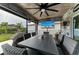 Enjoyable outdoor dining area with seating for eight, plus an outdoor ceiling fan and television entertainment at 8940 Royal River Cir, Parrish, FL 34219