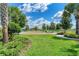 A beautiful community playground with swingsets and ample green space under a bright sky at 8940 Royal River Cir, Parrish, FL 34219