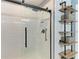 Tiled shower featuring a glass sliding door, rainfall shower head, and decorative shelves at 8940 Royal River Cir, Parrish, FL 34219