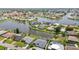 Stunning aerial view of waterfront homes with lush landscaping and private docks in a serene community at 965 E Gondola Dr, Venice, FL 34293