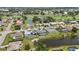 Aerial view of several homes featuring screen enclosed pools, manicured lawns, canals, and golf course views at 965 E Gondola Dr, Venice, FL 34293