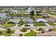 An aerial view shows lovely waterfront homes, meticulously landscaped in a desirable neighborhood with easy water access at 965 E Gondola Dr, Venice, FL 34293