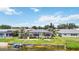 Aerial view of backyard featuring screen enclosed pool, manicured lawn, tropical plants, and dock with boat lift at 965 E Gondola Dr, Venice, FL 34293