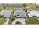 Aerial view of home with large driveway, landscaping and a screen enclosed pool, dock with boat lift and canal views at 965 E Gondola Dr, Venice, FL 34293