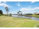 Beautiful backyard with green grass and tranquil water views from the canal at 965 E Gondola Dr, Venice, FL 34293