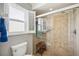Bathroom boasting a glass-enclosed shower, grab bars, and a comfortable built-in seat at 965 E Gondola Dr, Venice, FL 34293