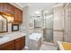 Bathroom featuring a soaking tub, vanity, decorative lighting, and glass-enclosed shower at 965 E Gondola Dr, Venice, FL 34293