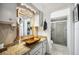 Bathroom features a decorative vanity with ample storage, an enclosed shower, and neutral tones at 965 E Gondola Dr, Venice, FL 34293