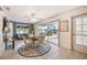 Dining area showcasing tile floors, a ceiling fan, with sliding doors to pool area and view of backyard at 965 E Gondola Dr, Venice, FL 34293