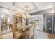 Elegant dining room features crystal chandelier and access to the outdoors, with lots of natural light at 965 E Gondola Dr, Venice, FL 34293