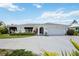 Charming single-story home featuring a well-maintained yard and an attached two-car garage at 965 E Gondola Dr, Venice, FL 34293