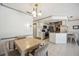 Bright kitchen and dinette area boasts white cabinets and tile floors, enhanced by modern stainless-steel appliances at 965 E Gondola Dr, Venice, FL 34293