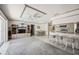 Open concept living room with media center, seamlessly connects to the kitchen and dining area at 965 E Gondola Dr, Venice, FL 34293