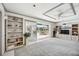 Bright living room boasts built-in shelving and sliding doors to the outdoor patio and pool area at 965 E Gondola Dr, Venice, FL 34293