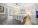 Main bedroom with a ceiling fan, shuttered window, carpet flooring, and patio door at 965 E Gondola Dr, Venice, FL 34293