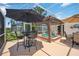 Screened-in patio with spa, and multiple seating areas for entertaining guests at 965 E Gondola Dr, Venice, FL 34293
