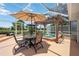 Screened in patio with a spa, pergola, and outdoor seating area with an umbrella at 965 E Gondola Dr, Venice, FL 34293