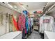 Walk-in closet has ample storage options with shelving, hanging rods, and neutral carpeting at 965 E Gondola Dr, Venice, FL 34293