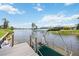 Waterfront property features a private dock with kayaks, and a canopy offering scenic views at 965 E Gondola Dr, Venice, FL 34293