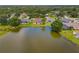Aerial view of lakefront homes with screened-in pools and lush landscaping at 11022 Pine Lilly Pl, Lakewood Ranch, FL 34202