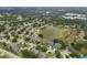 An aerial view of the neighborhood showcasing mature trees, many homes and multiple ponds at 11022 Pine Lilly Pl, Lakewood Ranch, FL 34202