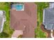 Aerial view of a home with a backyard pool and a well maintained roof and backyard at 11022 Pine Lilly Pl, Lakewood Ranch, FL 34202