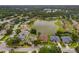 Aerial view of community with single-Gathering homes surrounding a lake at 11022 Pine Lilly Pl, Lakewood Ranch, FL 34202
