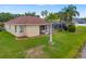 Backyard view of a single-Gathering home with pool, screened in patio, and lush landscaping at 11022 Pine Lilly Pl, Lakewood Ranch, FL 34202