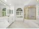 Bright bathroom boasts double sinks, shower, and marble floors for a luxurious feel at 11022 Pine Lilly Pl, Lakewood Ranch, FL 34202