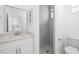Modern bathroom featuring walk-in shower and marble vanity at 11022 Pine Lilly Pl, Lakewood Ranch, FL 34202